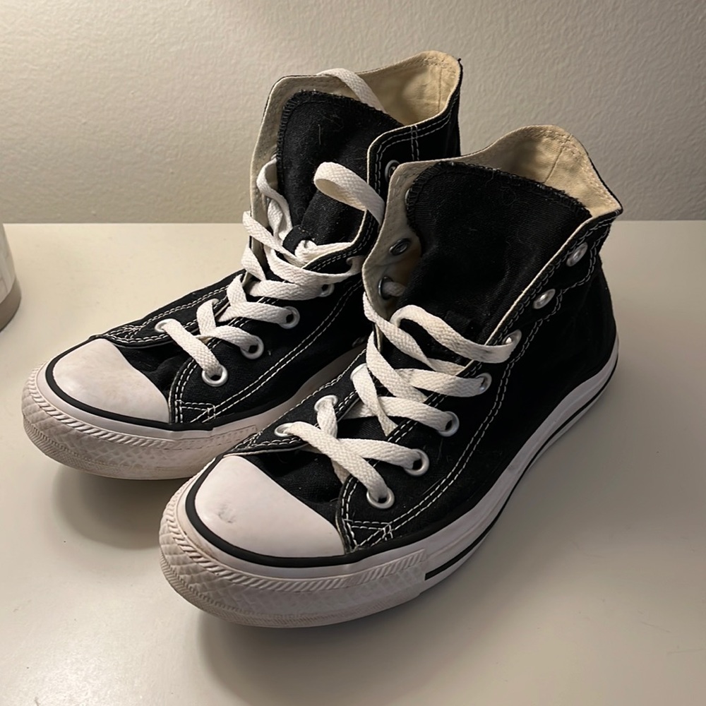 Black high top chuck taylor shoes